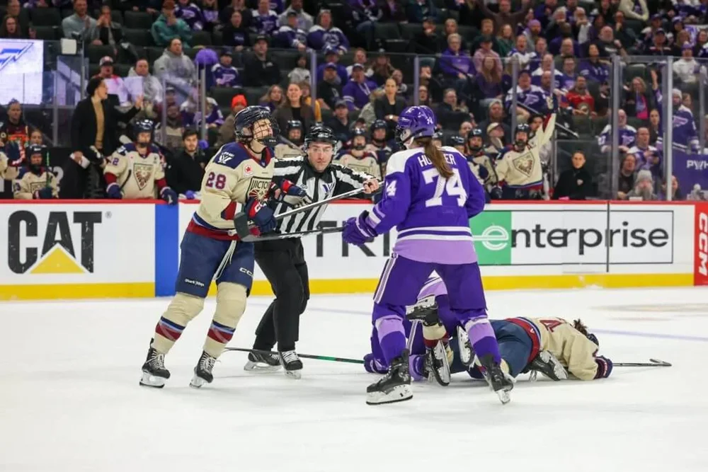 Montreal's Catherine Dubois and Minnesota's Abby Hustler fight during the first period of a PWHL playoff game